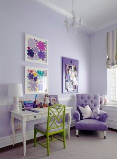 a purple chair sits in front of a white desk with a green chair and lamp