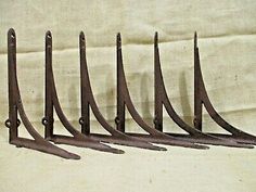 six antique cast iron shelf brackets with nails on each end, set of 8 pieces