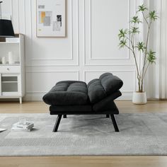 a black chair sitting on top of a rug in a living room