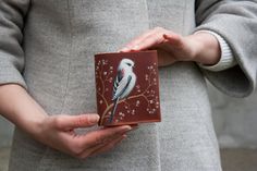 You will love it as soon as you hold it in your hands. The Long-tailed tit and white flowers on the mini red wallet looks very beautiful. HAND PAINTING Wallet with 100% hand-painted cute bird and flowers. In every work of art I put a part of my soul, heart and emotional content. I really like my work, that's why every thing is so special and brings pleasure and positive emotions to its owner. The bird painting is made of acrylic paints. After drying, the drawing is fixed at high temperature. Therefore, it becomes resistant to moisture and abrasion. Such a unique wallet design is available only in my store. This leather wallet locking with the button. Wallet is completely handmade, so each seam is securely fastened. It has a section for banknotes, 2 sections for cards, a pocket for coins an White Bird Painting, Titmouse Bird, How To Tie Ribbon, Unique Wallets, Wallet Design, Red Wallet, Cute Wallets, Brown Leather Wallet, Bird Painting