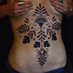 a woman's stomach with an intricate design on it