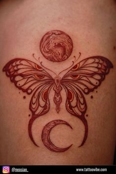 a butterfly tattoo on the back of a woman's shoulder with a crescent moon