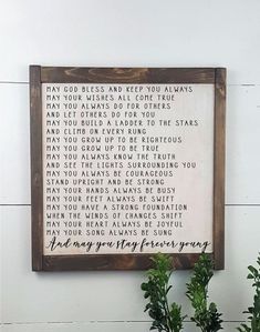 a wooden framed sign with words on it