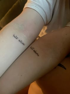 two people with matching tattoos on their arms, one has the word hello and the other is