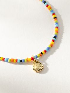 Every summer look needs our Beaded Shell Bracelet. This colorful bracelet features a gold shell charm that’s perfect for every beach trip. For a full look, pair this beaded bracelet with our Beaded Shell Necklace. | Multi-Colored Beaded Shell Bracelet | Women's Jewelry by Uncommon James Shell Bracelet, Gift Exchange, Shell Pendant, Pendant Bracelet, Shell Beads, Shell Necklaces, Jewelry Cleaner, Colorful Bracelets, Cleaning Jewelry