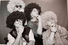 three people with curly hair are posing for a photo