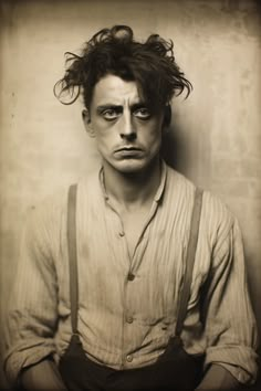 an old photo of a man with suspenders and hair in the middle of his face