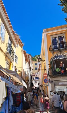 many people are walking down the narrow street