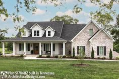 a white brick house with black shutters on the front