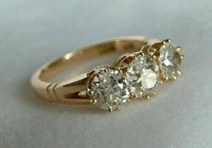 three stone diamond ring in yellow gold