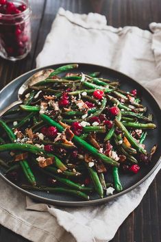 a plate with green beans and cranberries on it