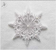 an intricate paper snowflake is featured in this image