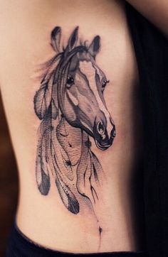 a woman with a horse tattoo on her stomach and the head of a horse that has feathers coming out of it