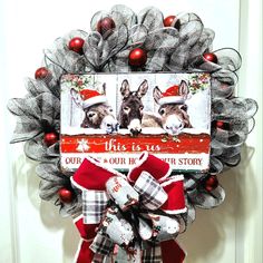 this is an image of a christmas mesh wreath with two dogs on the front door