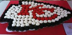 a heart shaped cake with red, white and black frosting