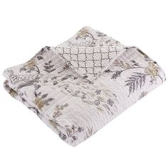 the comforter is made up of white and brown floral print, with two pillows on top