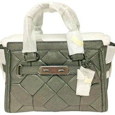 NEW WITH TAGS AND IN ORIGINAL PACKAGING! COACH Metallic Patchwork Swagger 27 Leather Bag Style: 34547 Color: Gunmetal Retail Price: $550.00   Metallic patchwork (quilted look) leather Inside zip, cell phone and multifunction pockets Zip-top closure, fabric lining Feet Dark gunmetal hardware Handles with 4" drop Longer strap with 19" drop for shoulder wear Approx. Measurements: 10 3/4" (L) x 7 3/4" (H) x 5 3/4" (W) Come with dust bag Please check out my store for many more fabulous finds "Foxwood Gunmetal Hardware, Bag Style, Coach Swagger Bag, Zip Top, 4 H, Fashion Bags, Bags Handbags, Leather Bag, Dust Bag