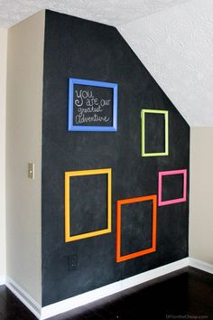 a black wall with colorful frames on it