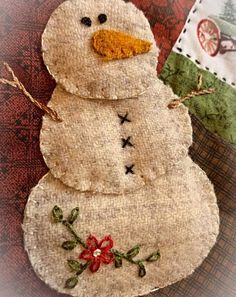 a close up of a snowman made out of fabric