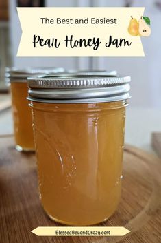 two jars filled with honey sitting on top of a wooden table next to each other