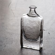 a glass bottle sitting on top of a wooden table