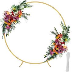 a circular wreath with flowers and greenery on it