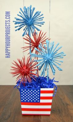 an american flag flower pot with red, white and blue flowers in it