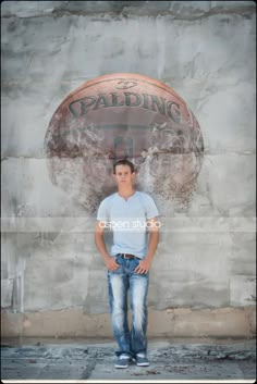 a young man standing in front of a basketball ball with the words balding on it