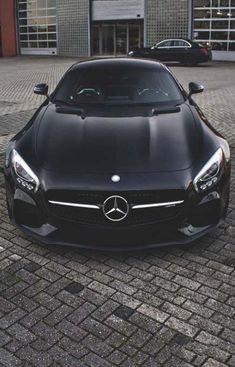 a black sports car parked in front of a building