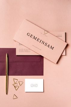 an envelope, pen and business cards on a pink background with the word gemsam