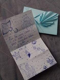 a piece of paper with writing on it next to an origami fish and starfish