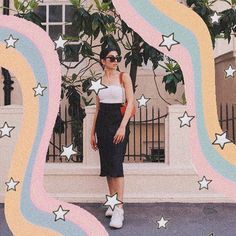 a woman standing in front of a building with stars on it