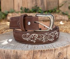 -Silver etched buckle -Floral embroidery -Genuine leather -COLOR BROWN Western Silver Embroidered Belt, Western Engraved Adjustable Belt, Western Style Engraved Adjustable Belts, Western Adjustable Engraved Belts, Western Style Adjustable Engraved Belts, Western Style Engraved Belts For Rodeo, Western Engraved Belts For Rodeo, Western Style Engraved Belt For Ranch, Engraved Western Belt For Ranch