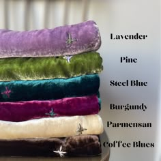 four different colored blankets stacked on top of each other with the words lavender, pine, steel blue, burgundy, and coffee blues