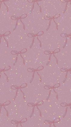 a pink background with glitter bows on it