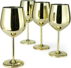 four gold wine goblets with black rims