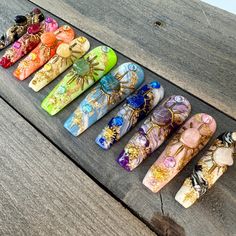 This stunning set features genuine stones like amethyst, rose quartz, aventurine, and lapiz lazuli. Each nail is it's own colour of the rainbow with a matching gemstone placed securely within a hand-drawn sun painted with gold chrome. I hand-paint the marbled effect on every nail, making each set unique and special. I truly hope you'll enjoy wearing these nails as much as I enjoy creating them! *The shape shown in the pictures is the XL COFFIN. *Colours may appear a little different due to your Planet Press On Nails, Press On Nails Aries, Handpainted Press On Nails, Nail Making, Acrylic Press On Nails, Moon And Sun, Celestial Art, Art Gold, Gold Chrome