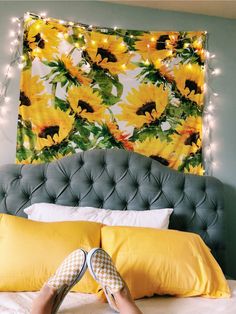 a bed with yellow pillows and sunflowers on the headboard is seen in this instagram