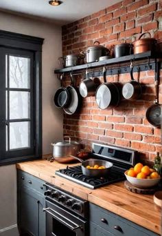 a brick wall in a kitchen with pots and pans hanging on the rack over the stove