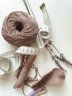 yarn, scissors and measuring tape are laid out on the table