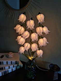 a vase filled with white flowers sitting on top of a table