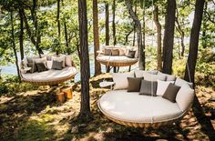 an image of a couch in the woods with pillows on it's back end