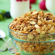 a glass bowl filled with granola on top of a table