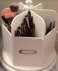 a white container with makeup brushes and other items in it