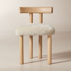 Inspired by modern Parisian apartments, the Perle natural shearling dining chair by goop is a sleek take on a classic silhouette with its deep, armless profile, vertical lines and contoured T-back. Soft, tactile shearling provides an elegant counterpoint to the lightly wirebrushed and cerused American white oak certified sustainable by the Forest Stewardship Council r FSC, while an unlacquered brass andamp;quot;gandamp;quot; medallion on the front leg lends a refined final flourish. Whether in t Black Leather Bed, Modern Parisian Apartment, Modern Parisian, Wood Canopy, Wood Counter Stools, Leather Sectional Sofa, Grey Dining, Leather Bed, Vertical Lines