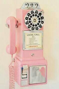 an old fashioned pink rotary phone on display