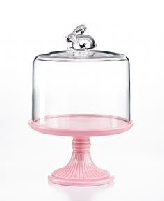 a pink cake stand with a glass cover on top