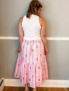 Transform your summer wardrobe with our Pink Tulip Tiered Skirt. This playful and fun piece features a stunning pattern and beautiful colors, perfect for bringing a pop of color to any outfit. With a smocked waist and lining, it not only looks great but also offers a comfortable fit. A must-have for any fashion-forward individual looking to make a statement! Fit is true to size. Emily is 5'8" wearing a medium. Small (0-4) Medium (6-8) Large (10-12) XL (14-16) Feminine Relaxed Maxi Skirt For Vacation, Spring Vacation Gathered Maxi Skirt, Feminine Tiered Maxi Skirt For Vacation, Spring Vacation Maxi Skirt With Gathered Detail, Summer Flared Maxi Skirt With Elastic Waistband, Bohemian Gathered Skirt Bottoms For Day Out, Summer Vacation Gathered Maxi Skirt, Feminine Gathered Maxi Skirt For Summer, Bohemian Gathered Skirt For Day Out