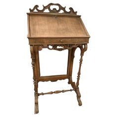 an old wooden desk with carvings on the top and bottom edge, sitting against a white background