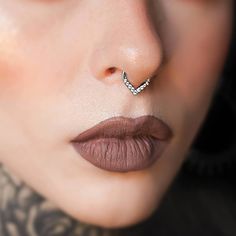 a woman's nose has a piercing on it